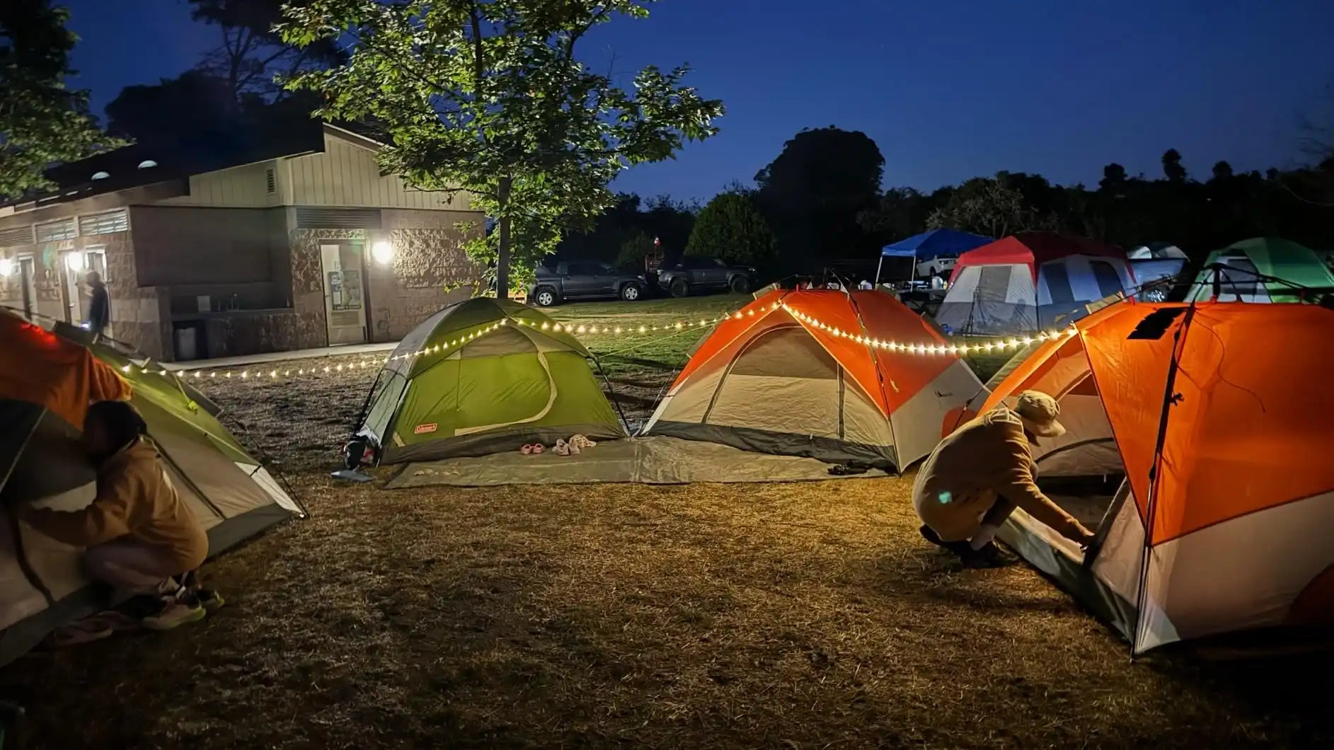 Illuminated camping tents at night.